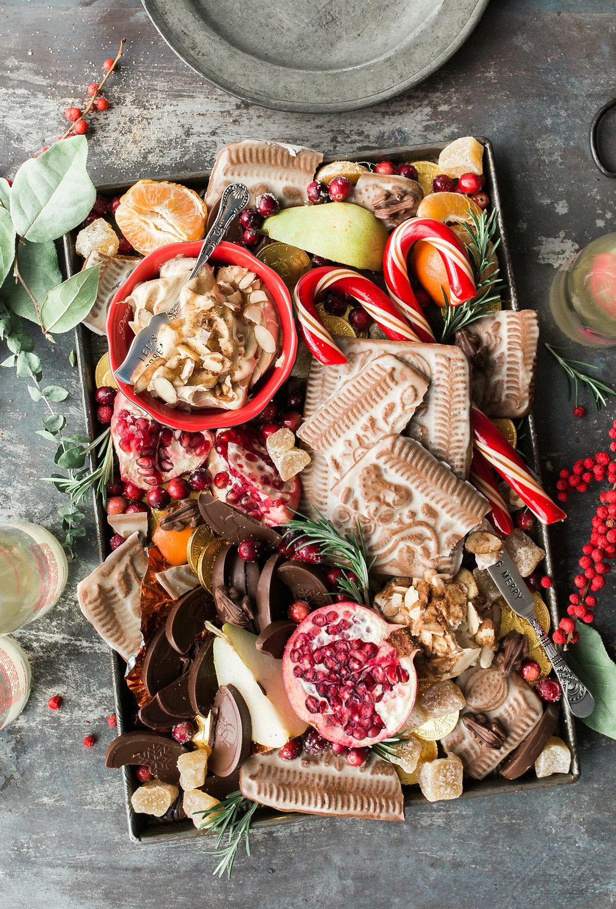 A holiday charcuterie board with fruit, cheese, and seasonal accents.